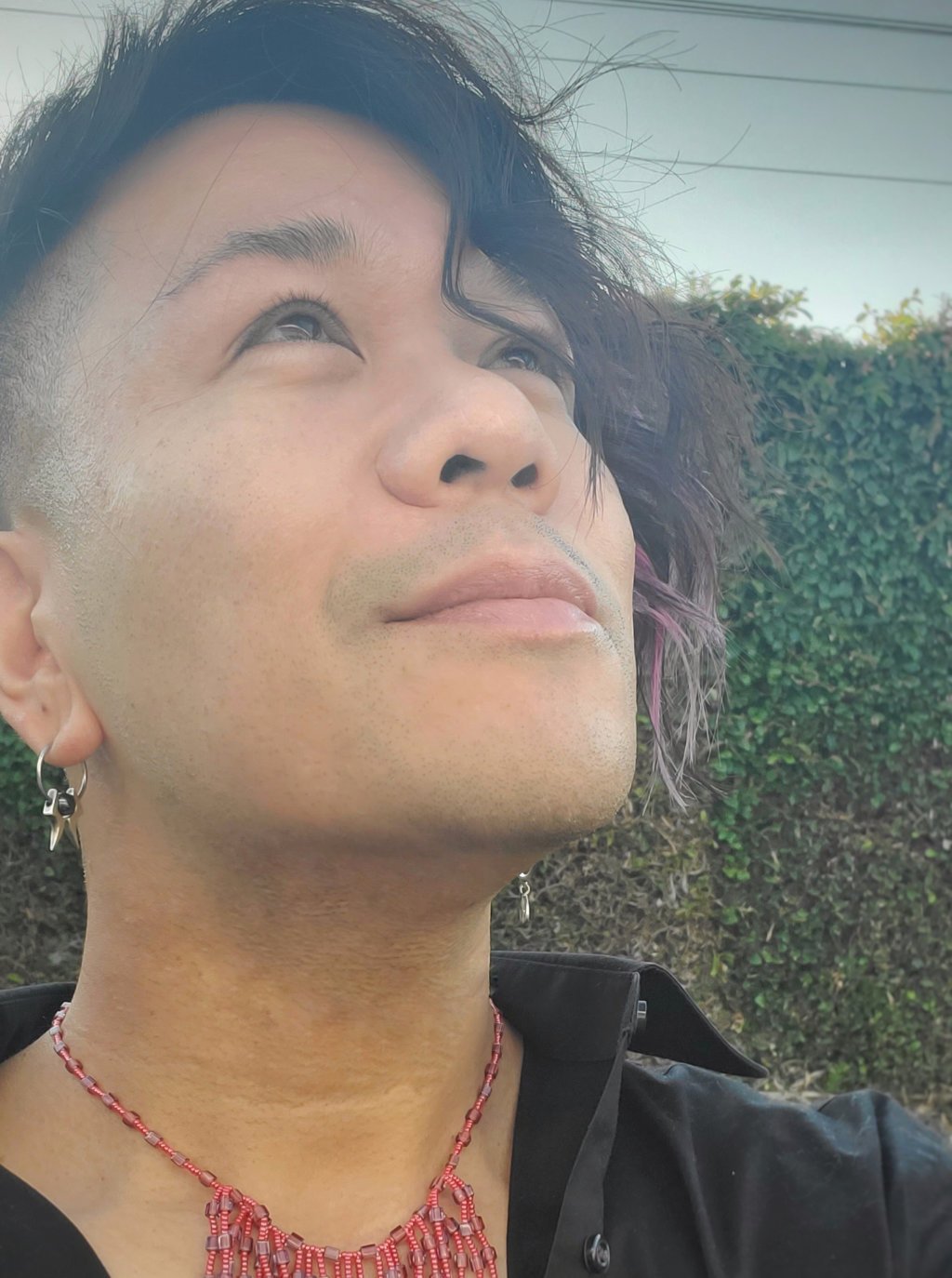 Ren Zen smiles and looks upward